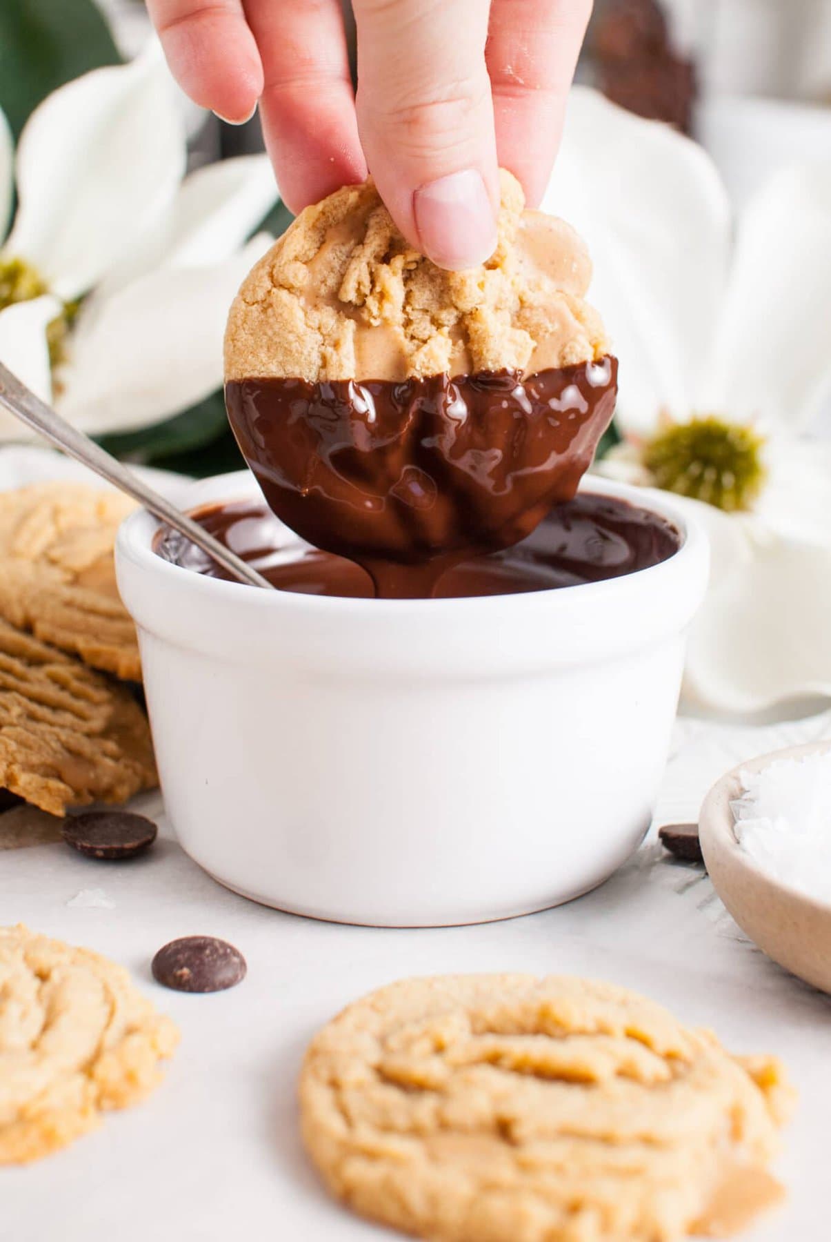 Dipping the cookies into the chocolate.
