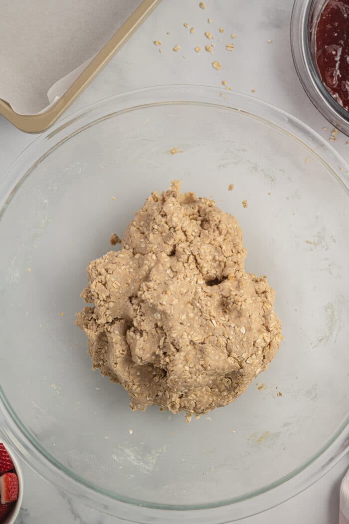 Finished oatmeal dough in a glass bowl.