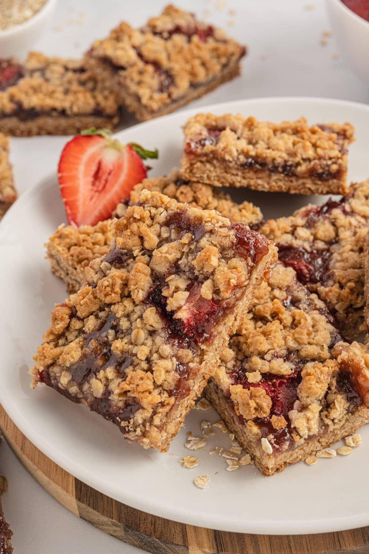 Strawberry oatmeal bars stacked on a plate.