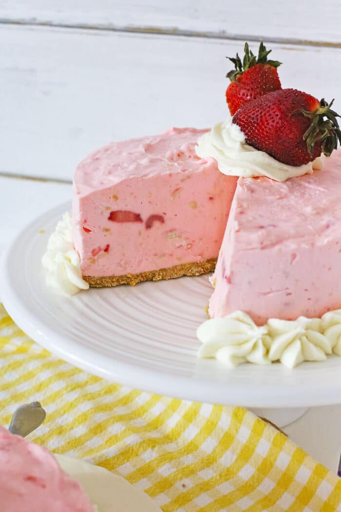 Strawberry Pie Cheesecake on a cake stand.