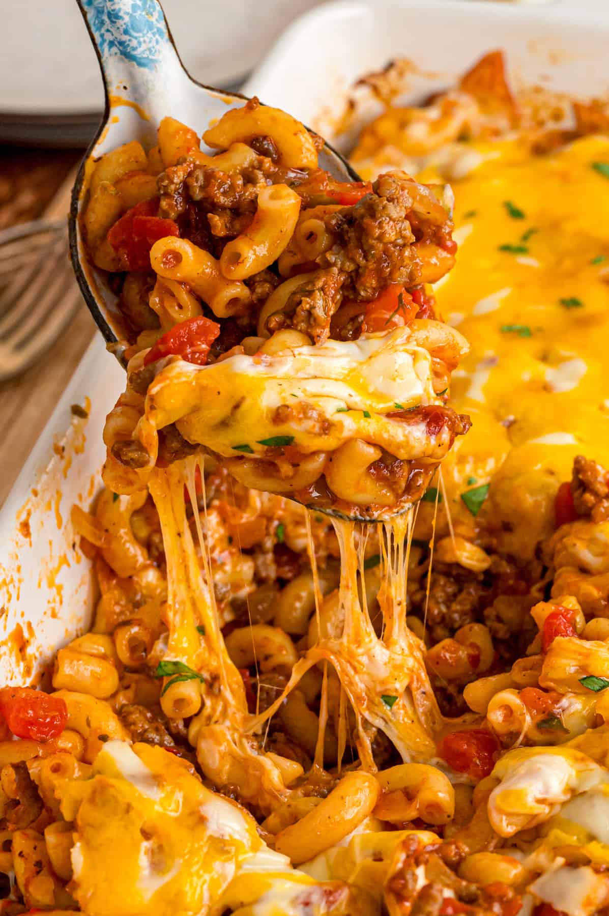 A spoon serving cheeseburger casserole