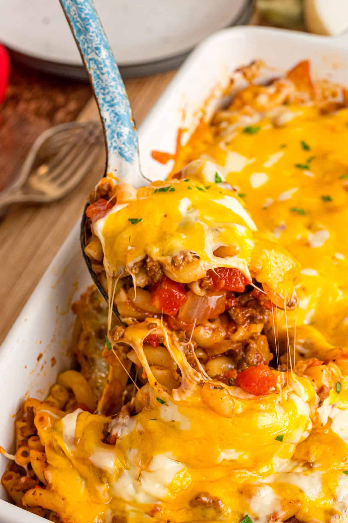 A spoon serving cheeseburger casserole