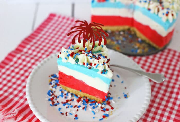 4th of July Cheesecake on a white plate with sprinkles