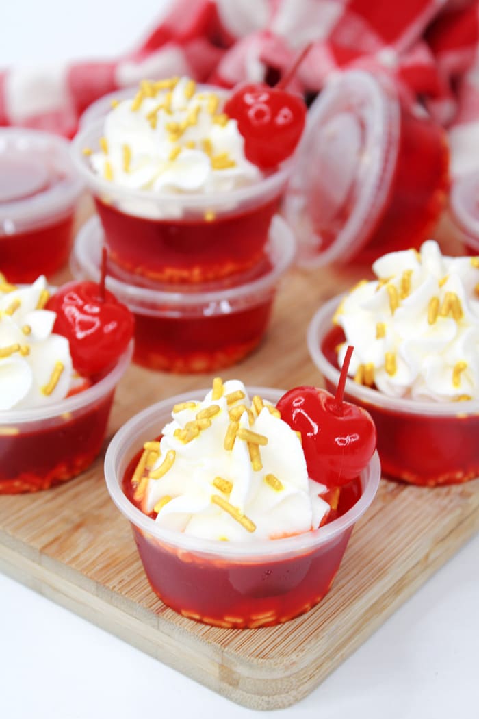 Perfect for 4th of July, Cherry Jell-O with cherry liqueur and whipped cream vodka make the best Cherry Bomb Jello Shots!
