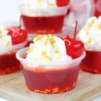 Perfect for 4th of July, Cherry Jell-O with cherry liqueur and whipped cream vodka make the best Cherry Bomb Jello Shots!