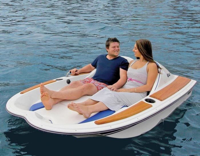 Two people on a One-Person Electric Watercraft.