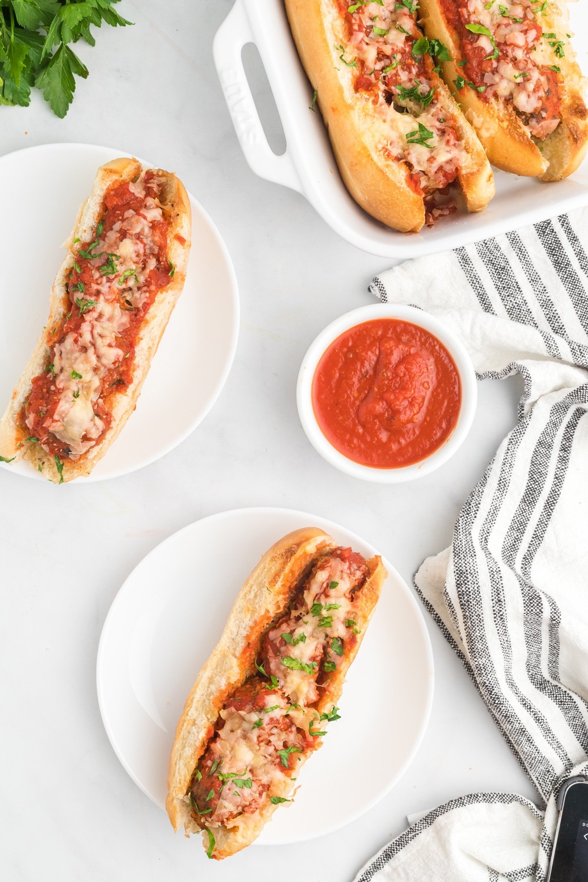 Overhead view of two meatball subs on plates