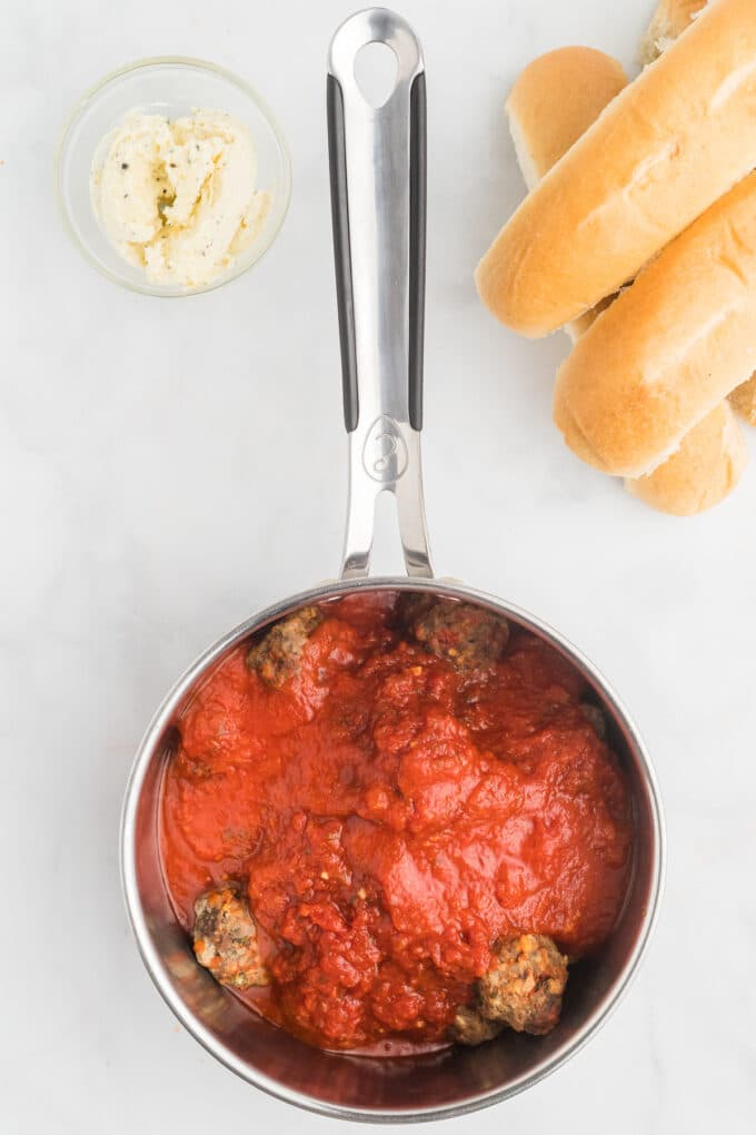 Overhead view of meatballs and marinara sauce in a saucepan