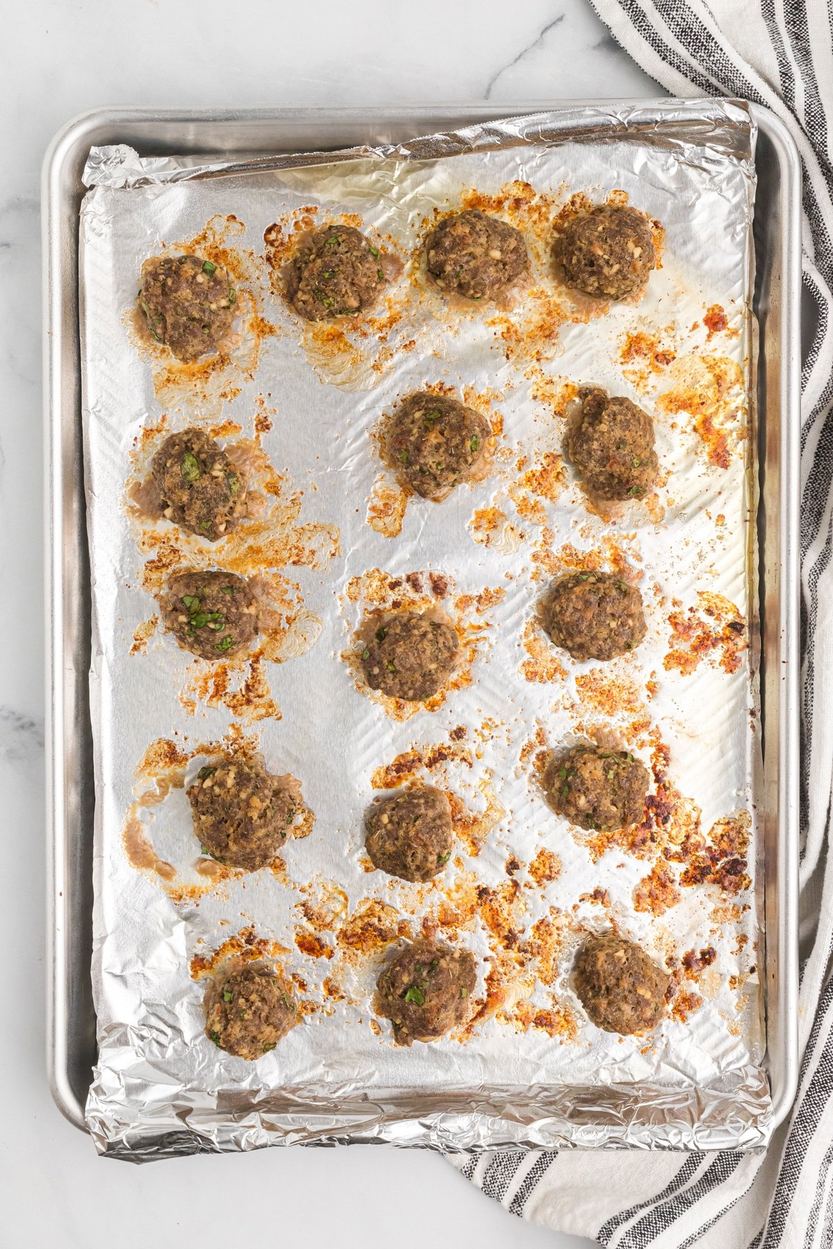 Cooked meatballs on a baking sheet