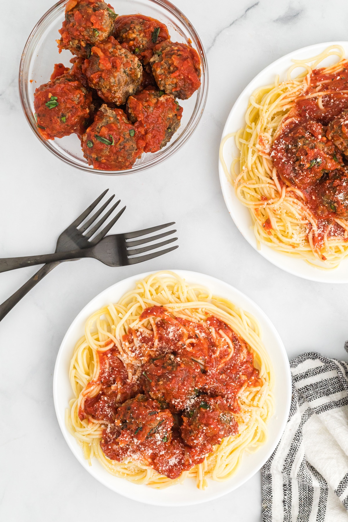 Overhead of a plate of spaghetti and meatballs and a bowl of meatballs
