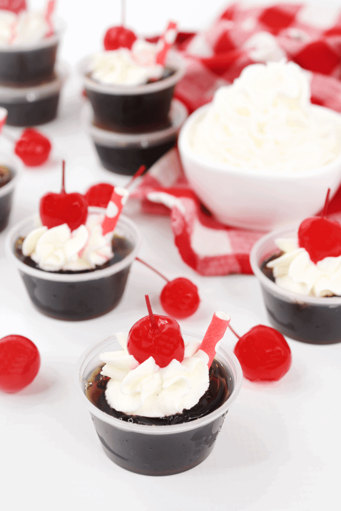 Root Beer Float Jello Shot topped with cherries.