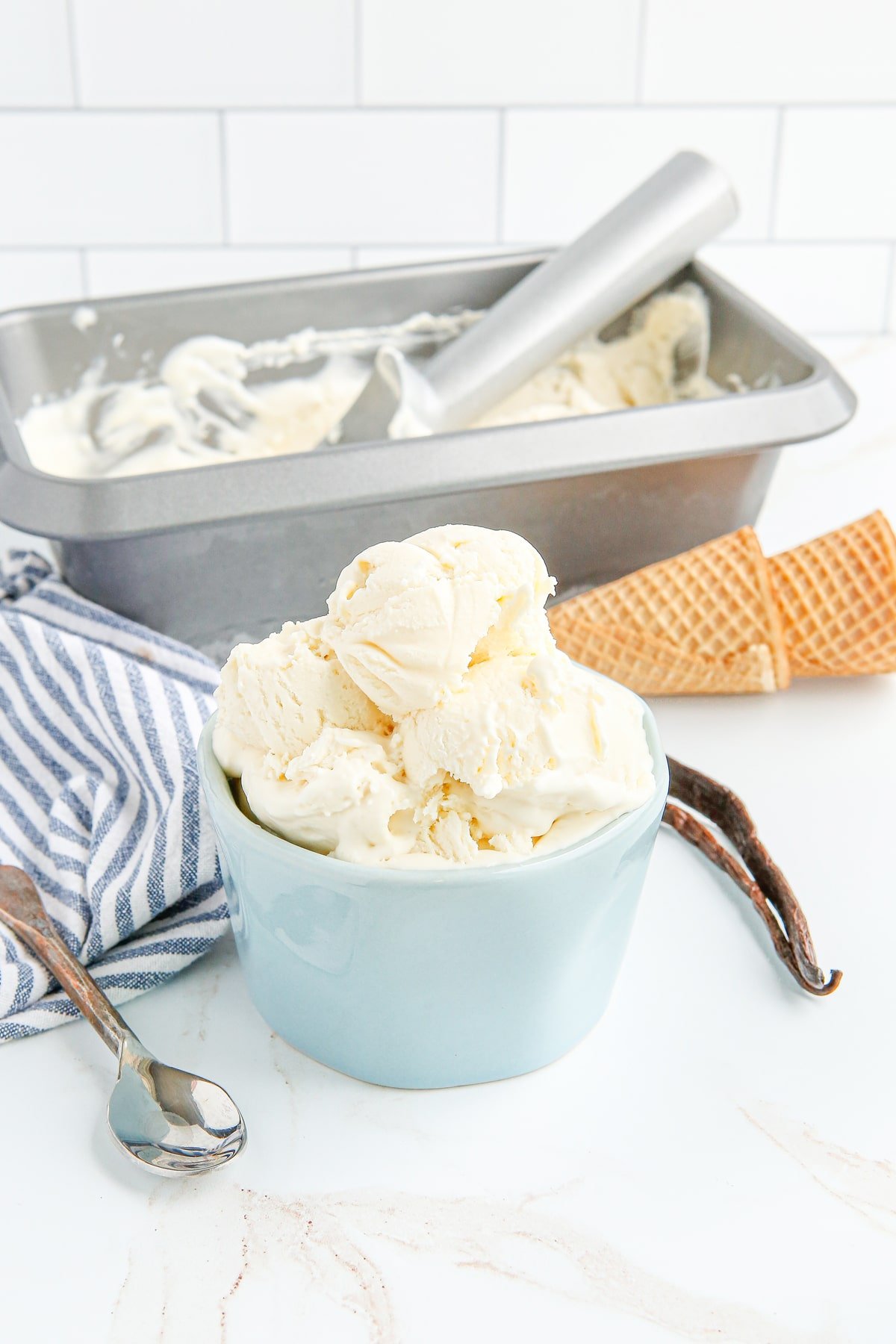 A blue bowl of vanilla ice cream