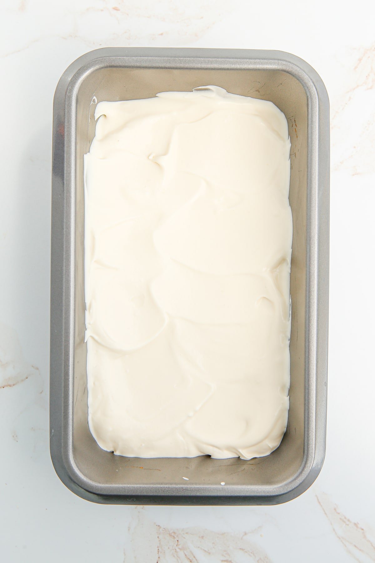 A loaf pan of vanilla ice cream