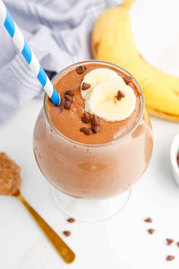 Chocolate Banana Smoothie with a blue straw.
