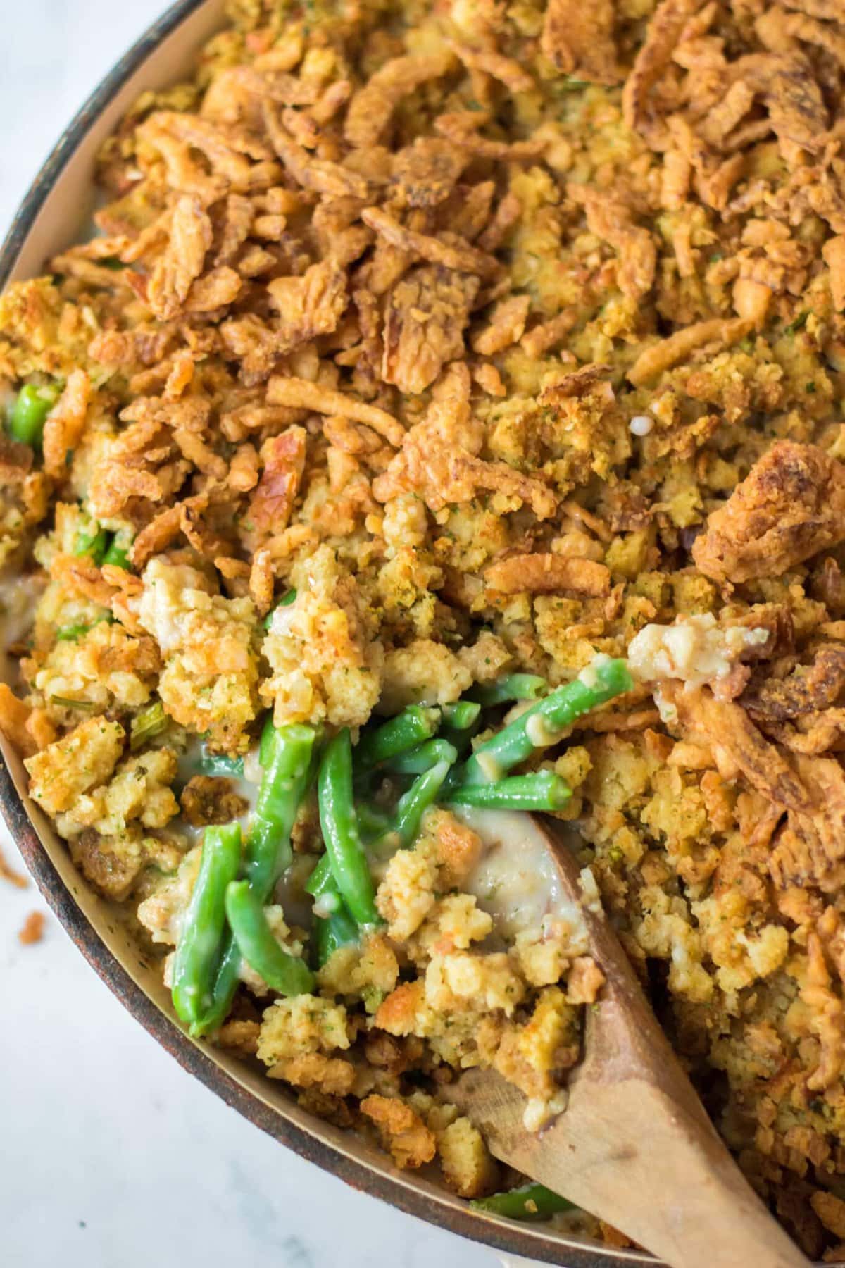 A spoon lifting up the Green Bean Stuffing.