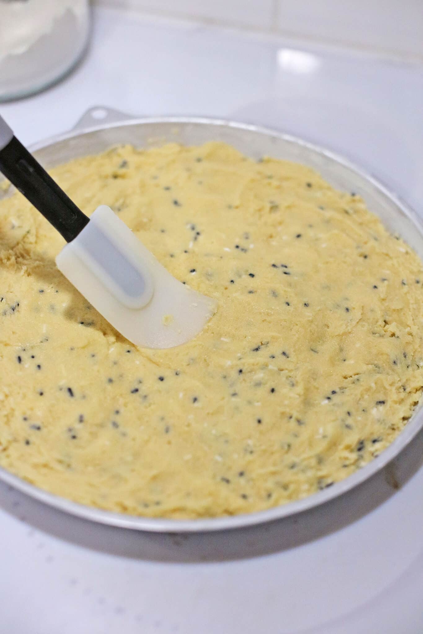 Adding the dough into the pan.