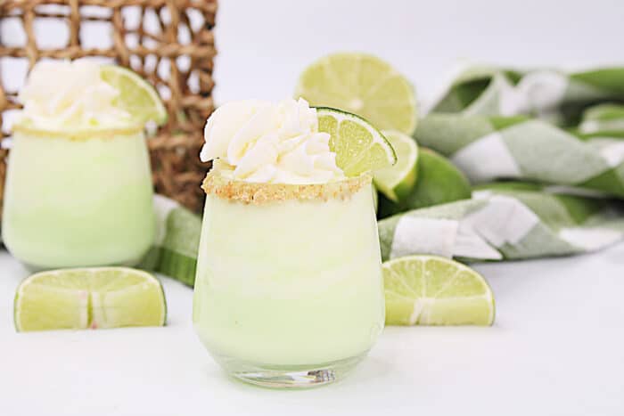 Key Lime Pudding Shots on a white table.