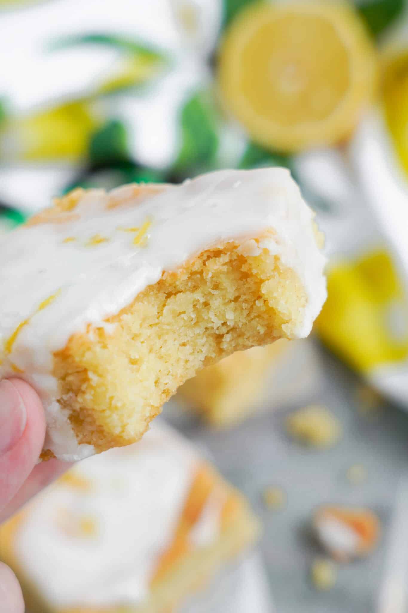 A hand holding the Lemon Cookie Bars.