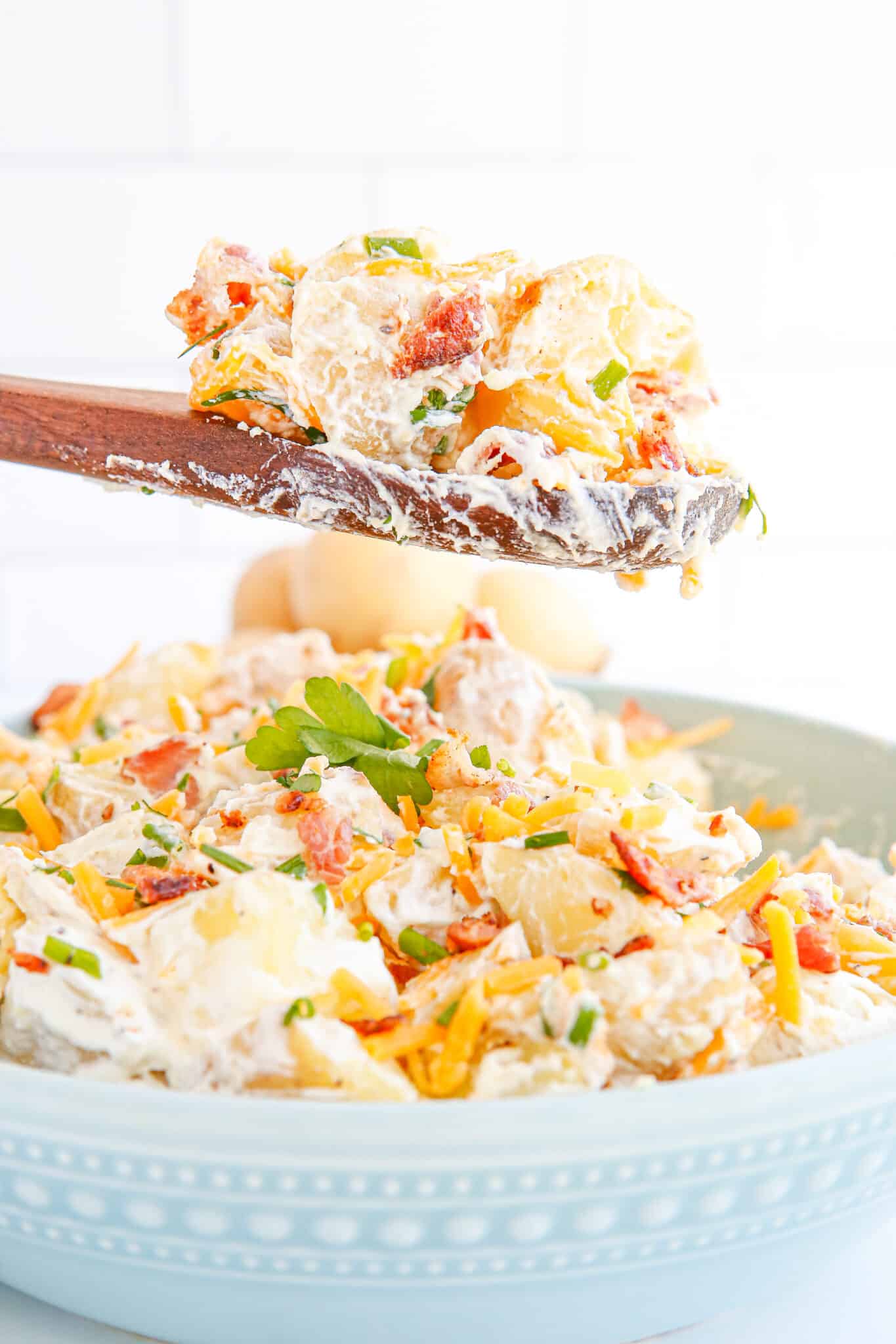 Loaded Potato Salad on a spoon.