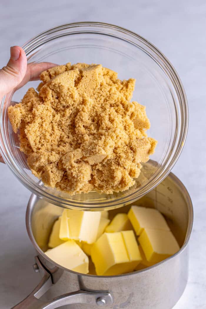 Adding brown sugar to a saucepan with butter