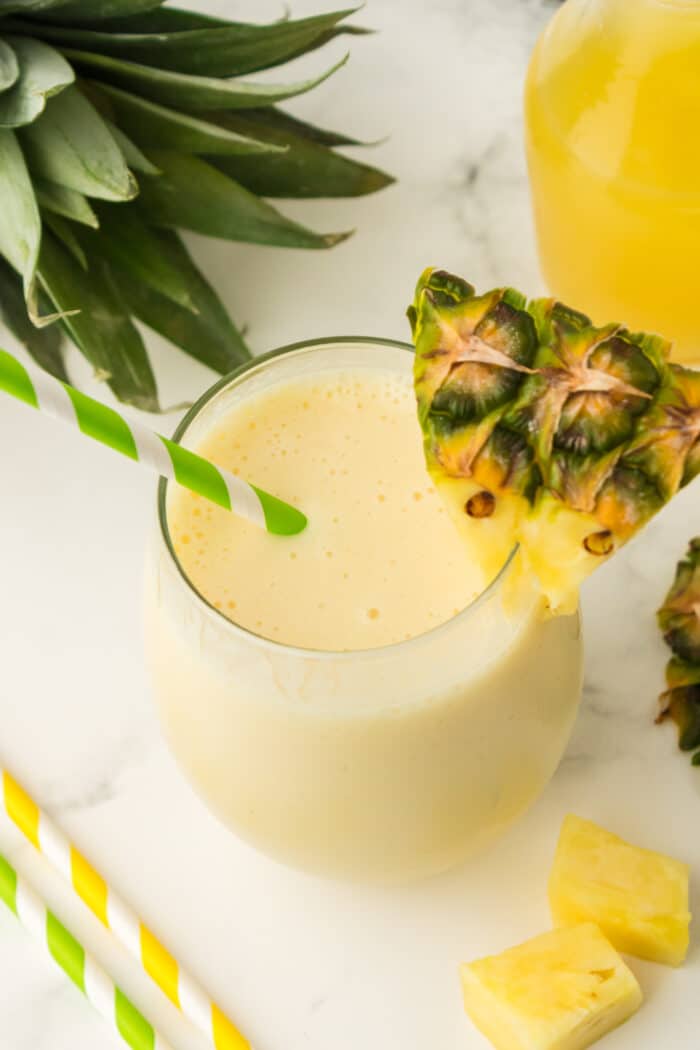 Pineapple Smoothie garnished with a fresh pineapple.