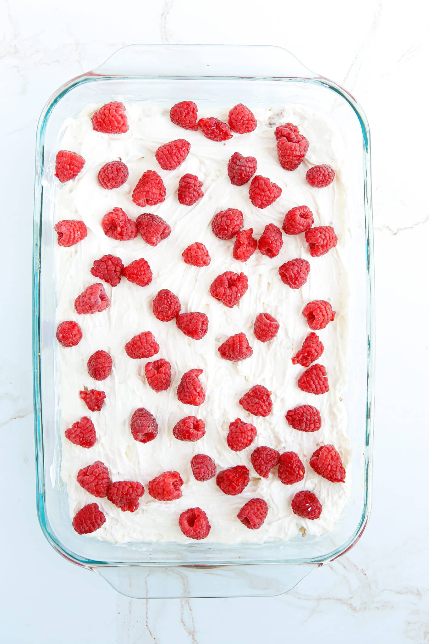 Adding the fresh raspberries on top.