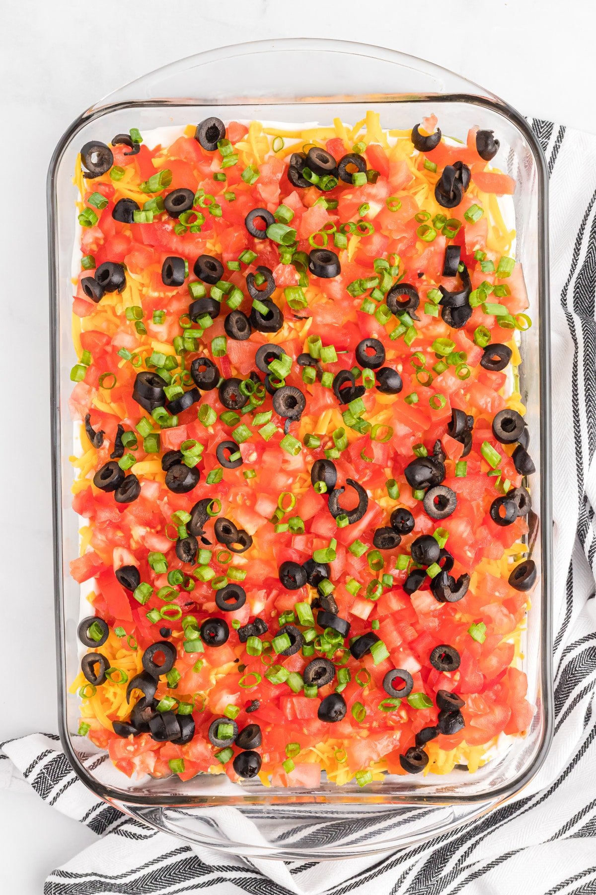 Overhead view of 7 layer dip in a glass baking dish