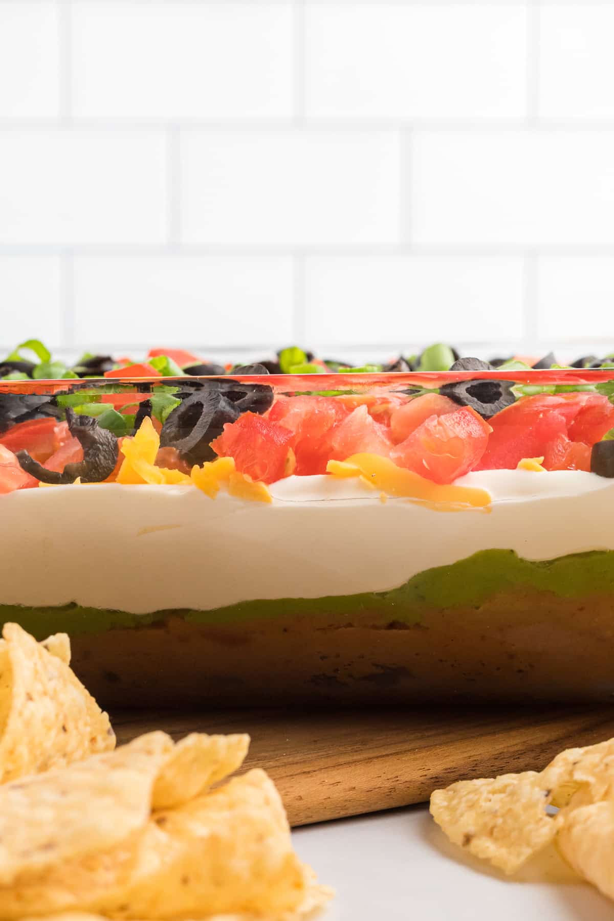 The view of a baking dish of 7 layer dip from the side so you can see the layers