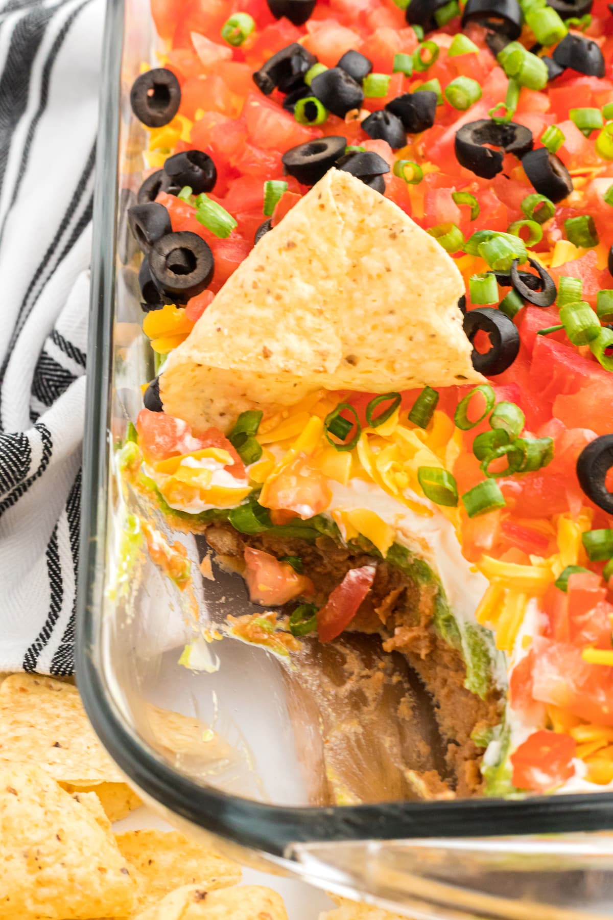 7 layer dip with a corner missing and a chip
