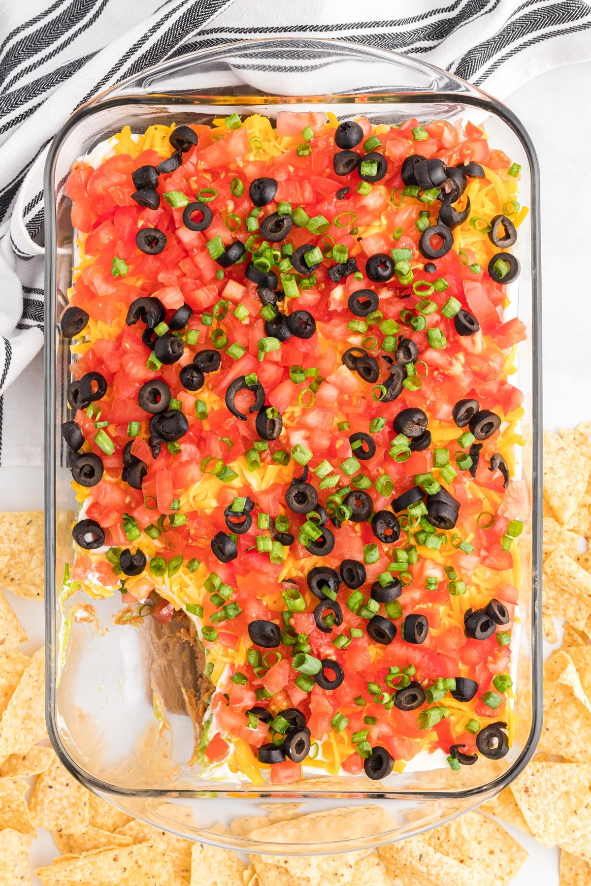 Overhead view of 7 layer dip with a corner of dip missing