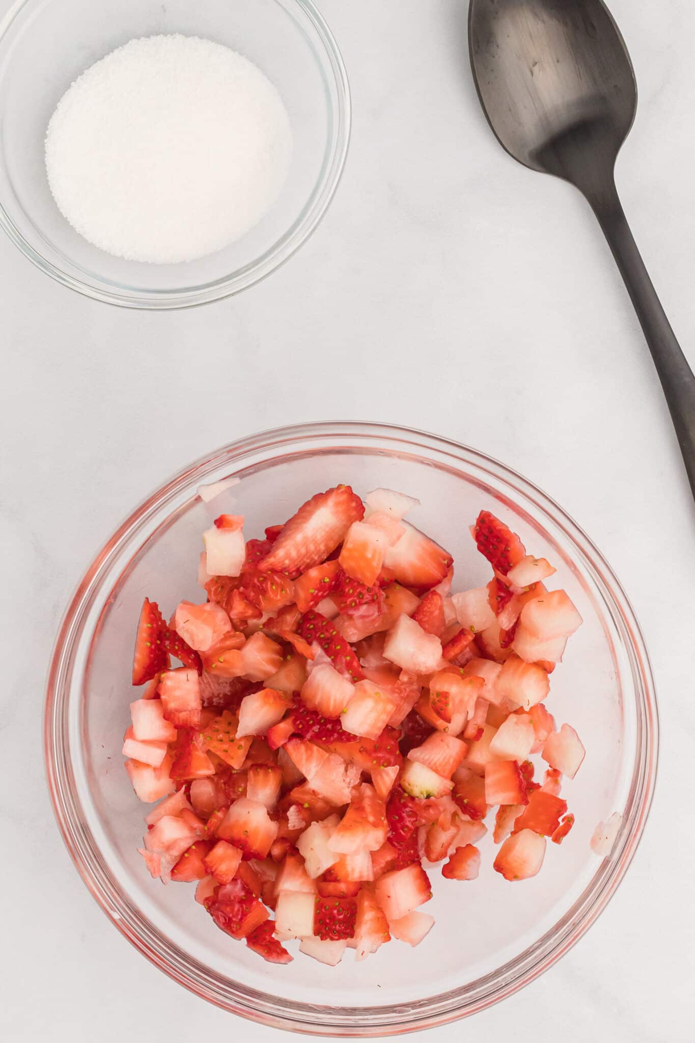 Mixing the strawberries and sugar.