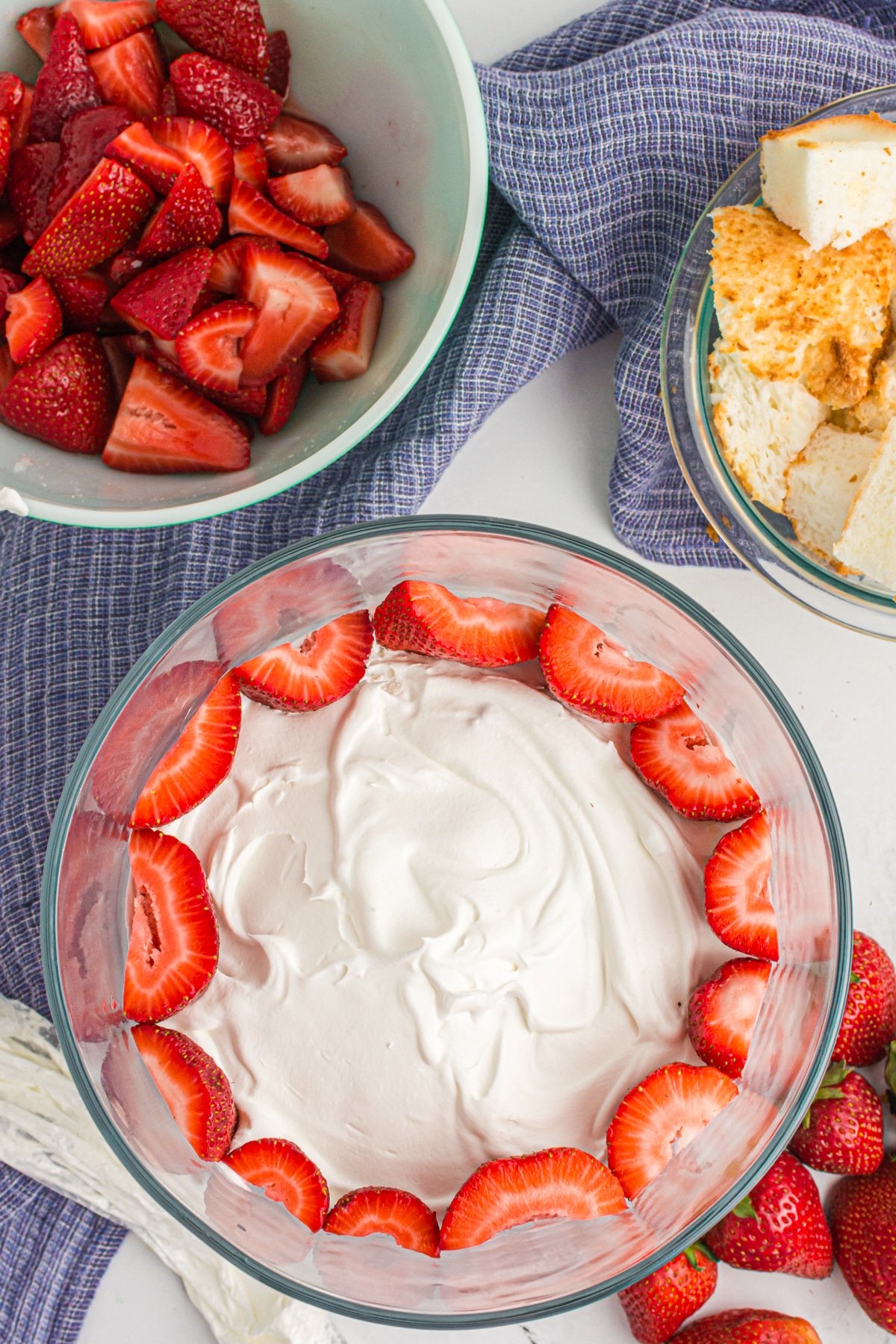 Putting strawberries in the Strawberry Trifle.