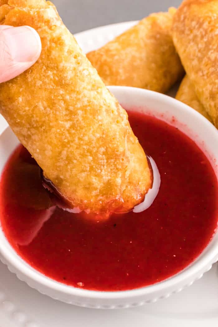 Eggroll dipped in Sweet and Sour Sauce