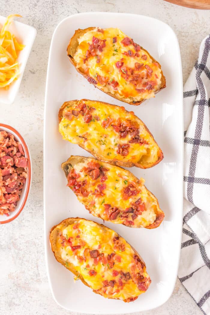 Twice Baked Potatoes topped with cheese.
