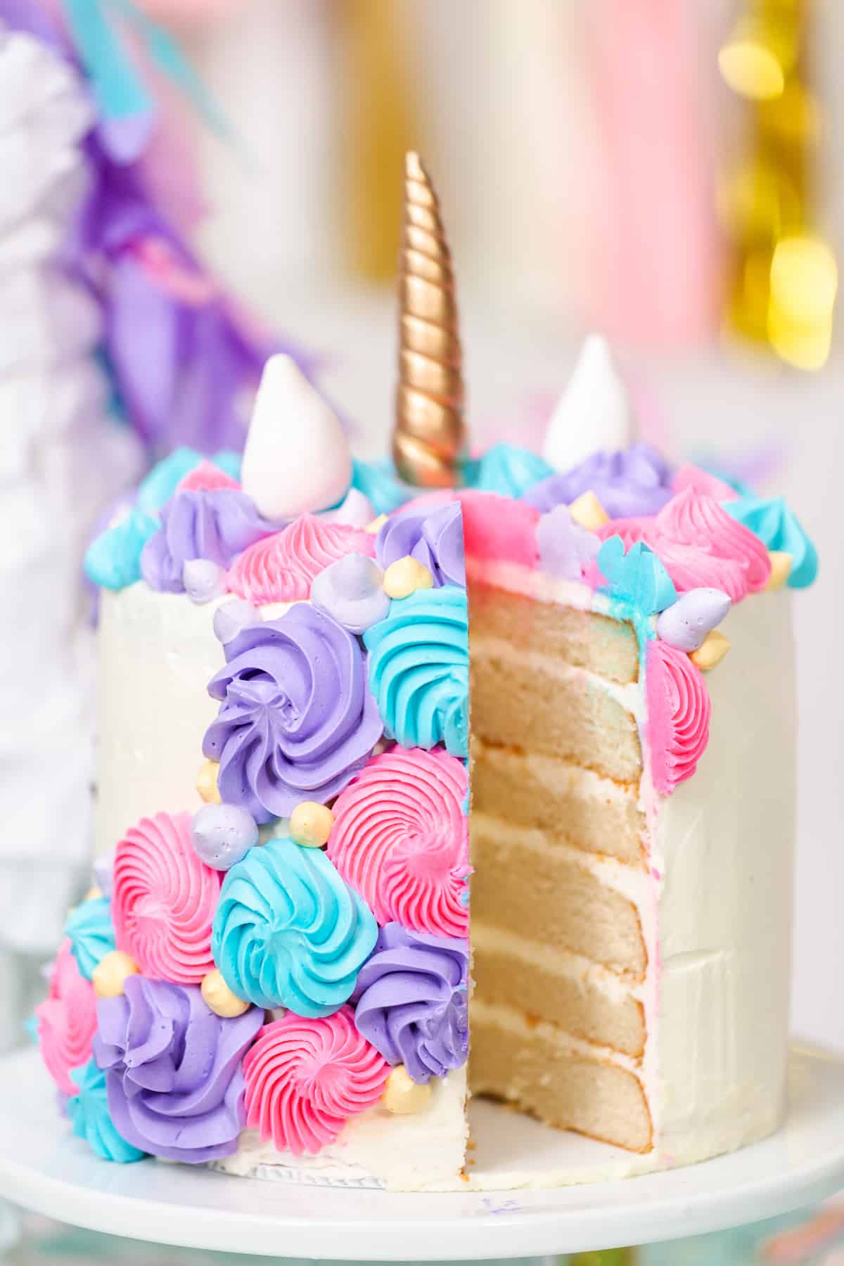 A unicorn cake with a slice missing
