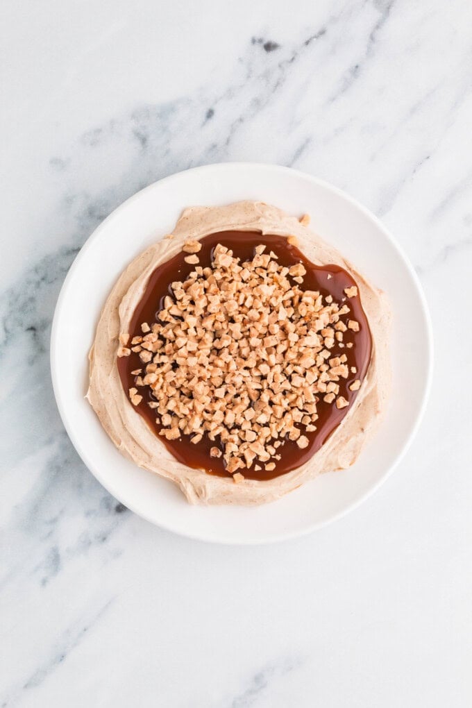 Ready in 5 minutes, this Caramel Apple Dip is made with cream cheese, brown sugar, and caramel sauce for an easy fall treat. Overhead view of a plate of caramel apple dip
