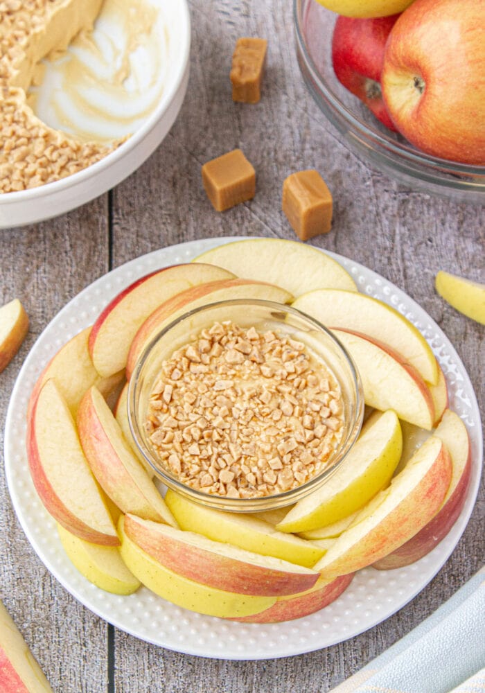 Caramel Apple Dip surrounded by sliced apple.