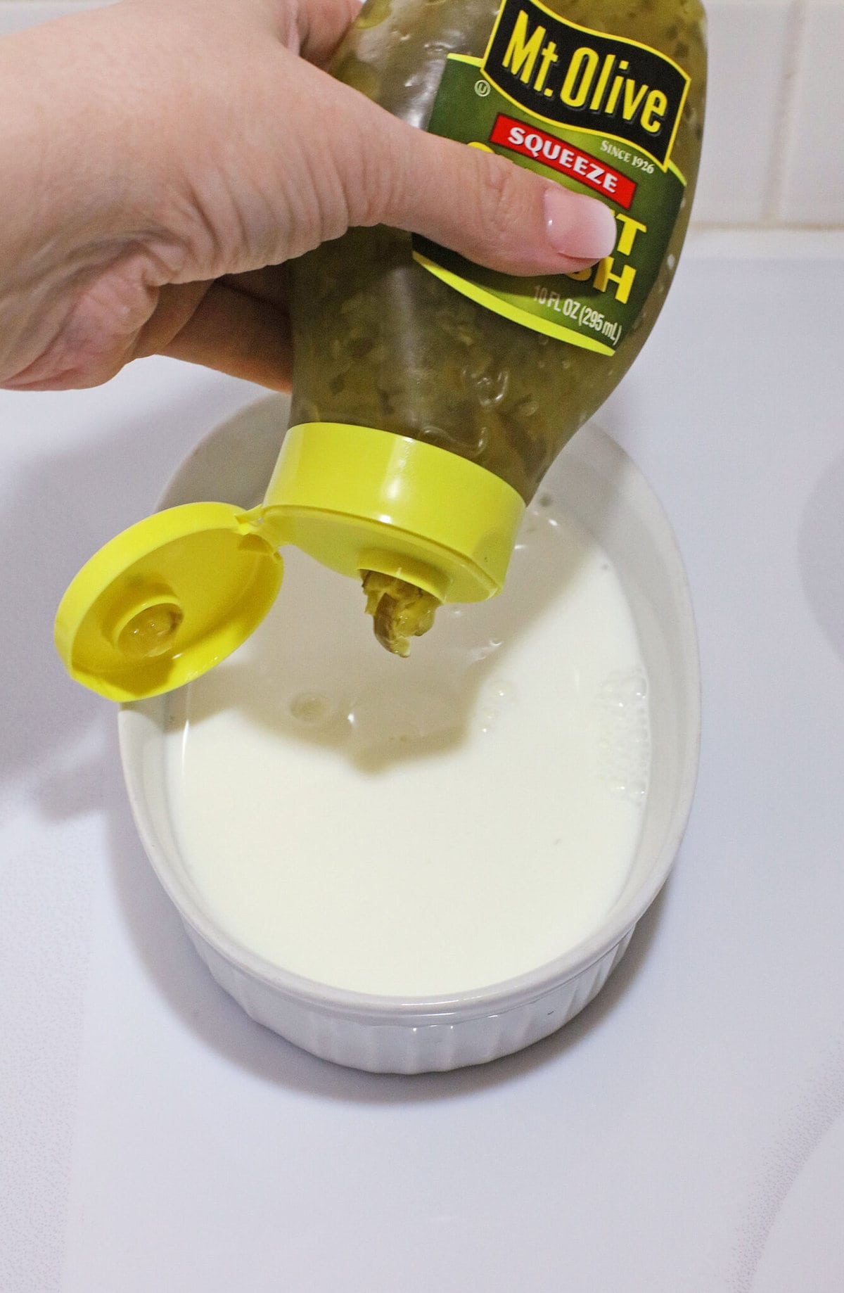 Adding the pickle juice into the milk.