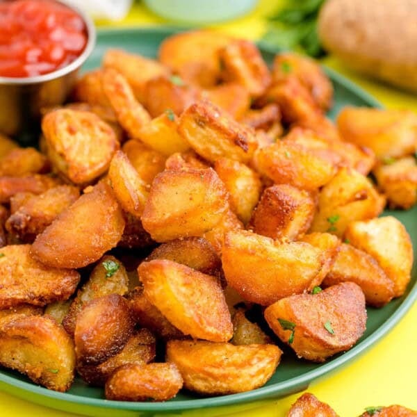 Duck Fat Potatoes on a green plate.