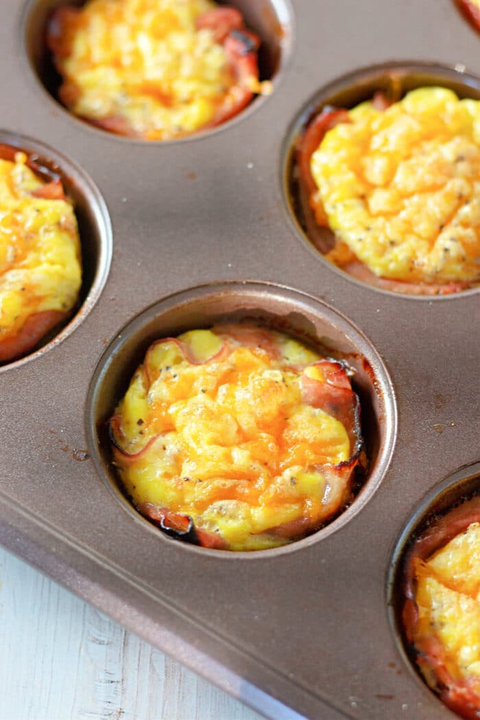 freshly baked egg and cheese muffins in a pan.