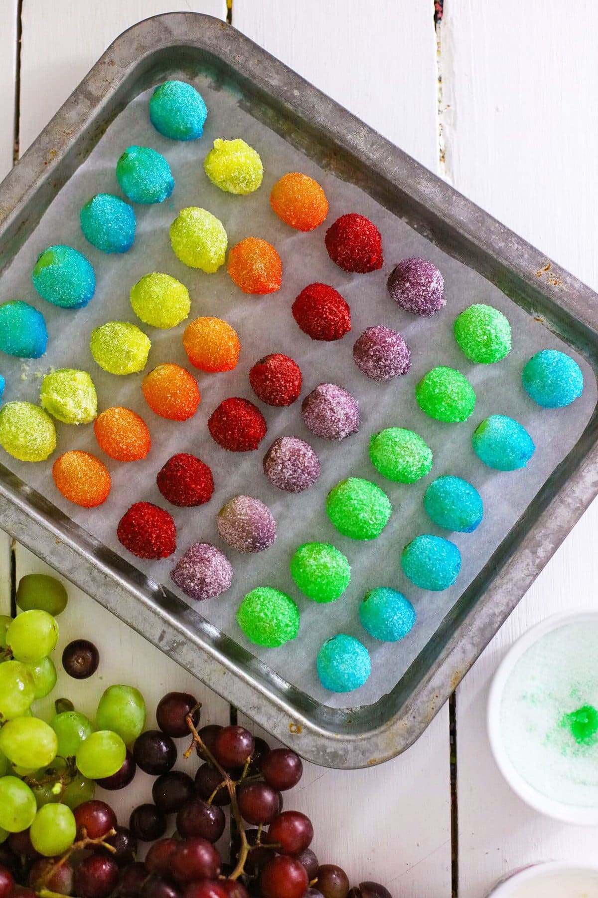 The coated grapes on a cookie sheet.