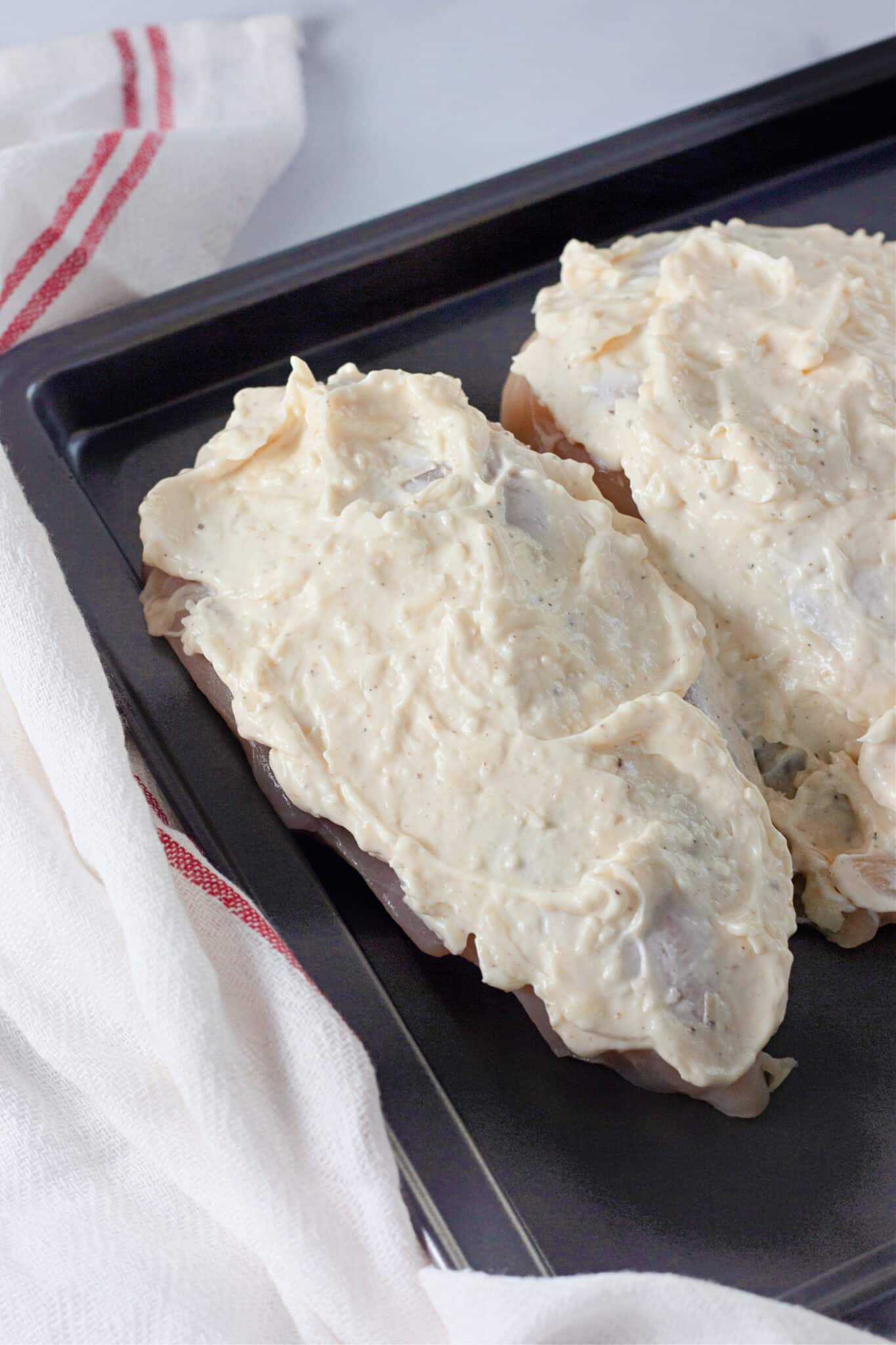 spreading the topping over the chicken.