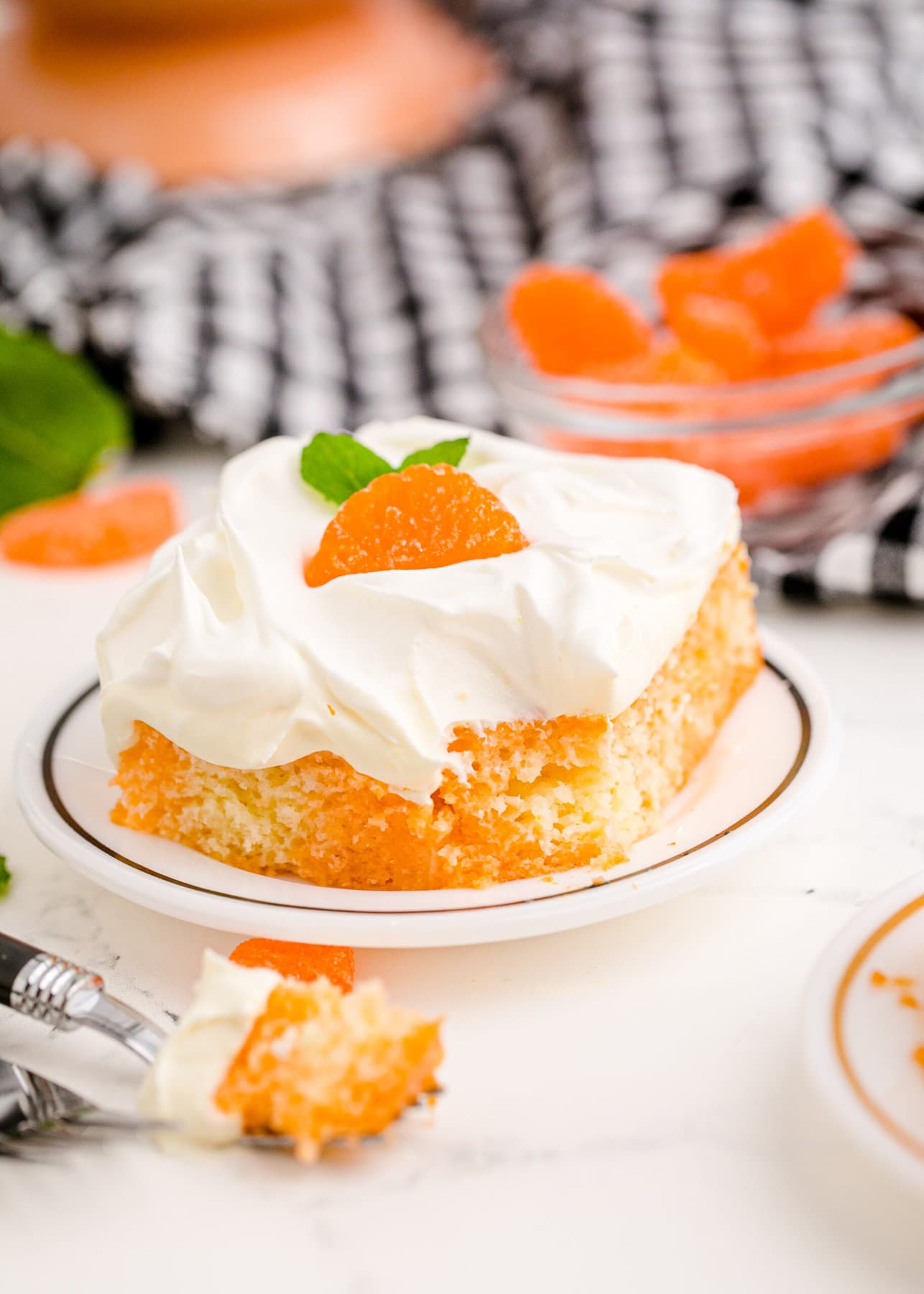 a slice of Orange Poke Cake on a plate
