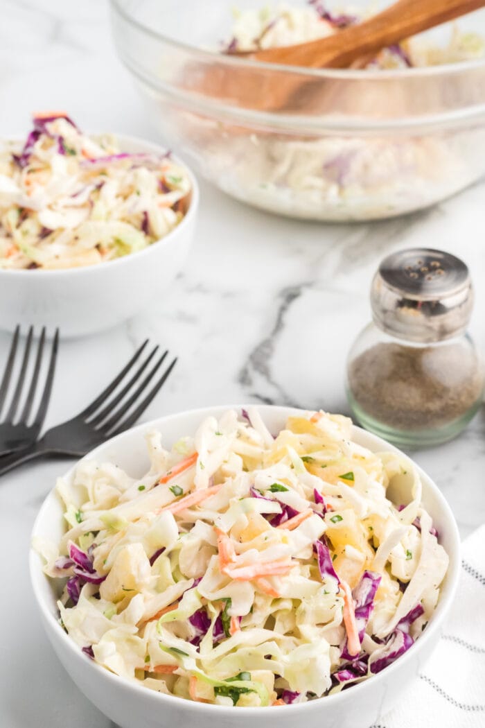 pineapple coleslaw in a white bowl