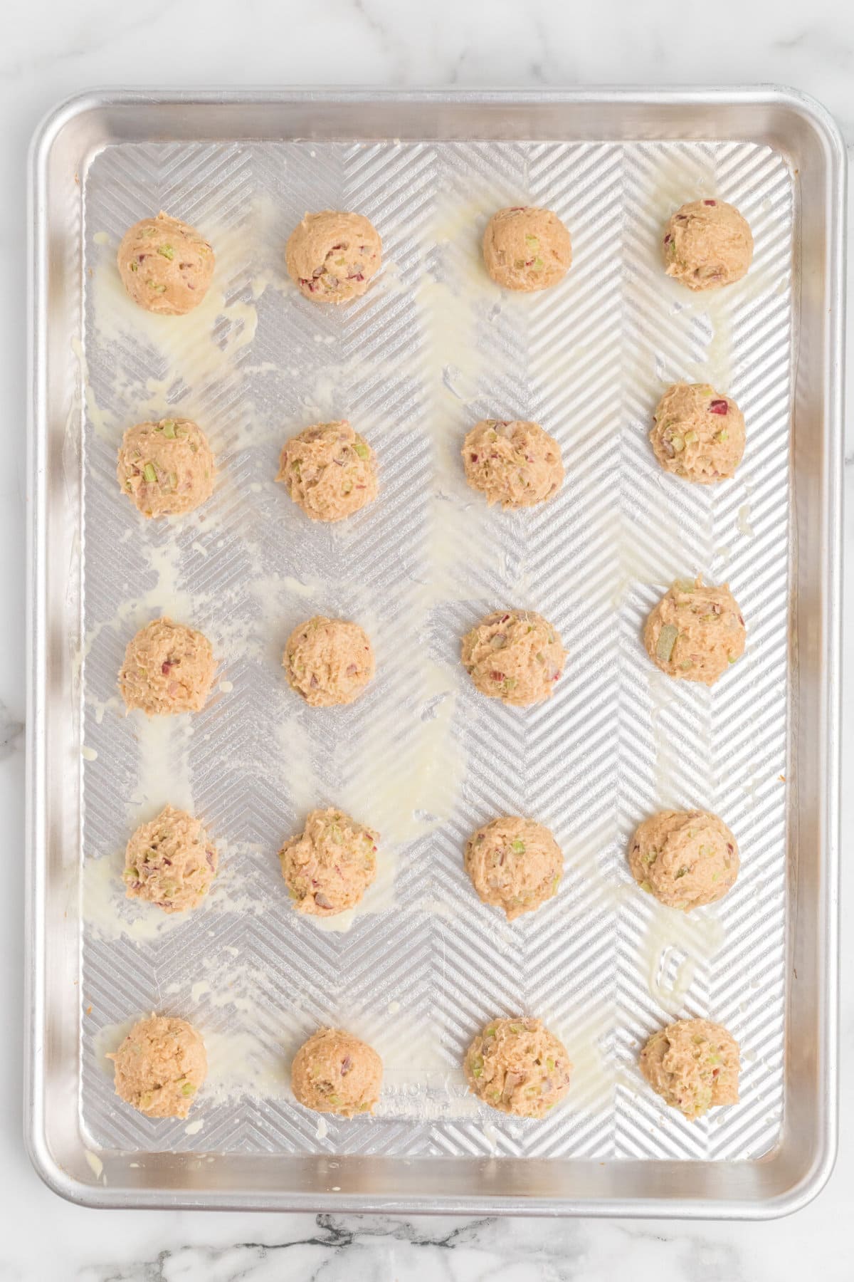The dough balls on a tray.