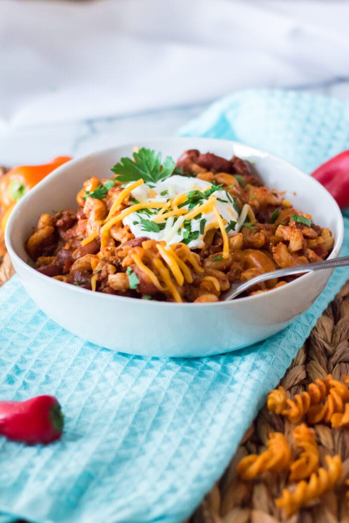 Slow Cooker Chili Mac on a blue cloth.