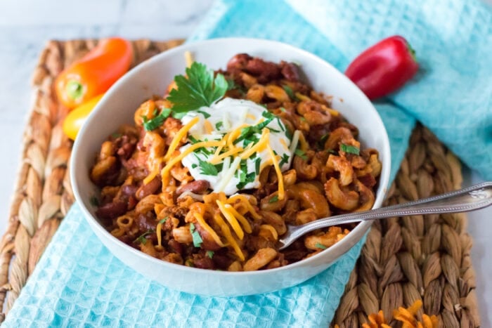 Slow Cooker Chili Mac with sour cream on top.