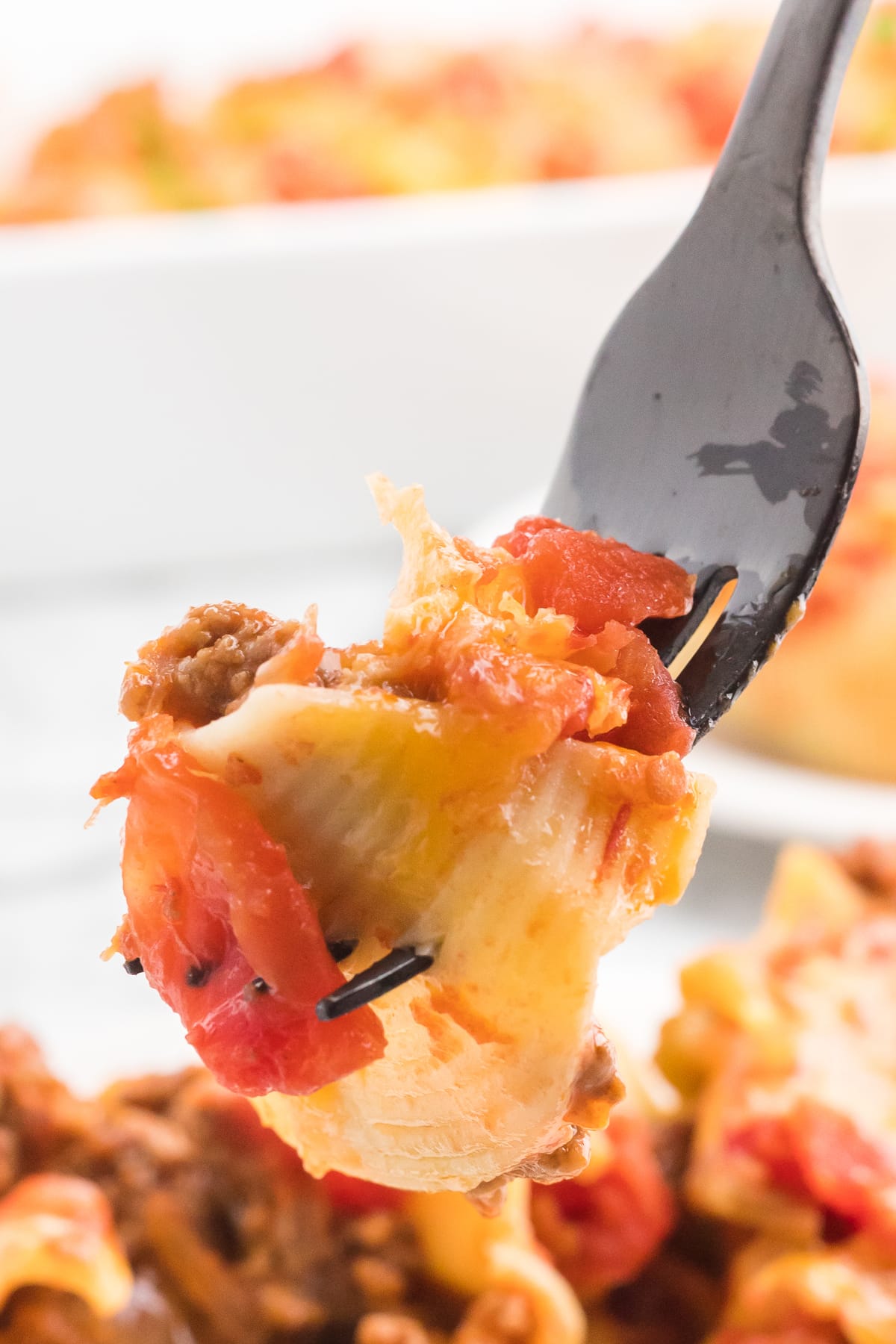 A fork with a piece of stuffed taco shells