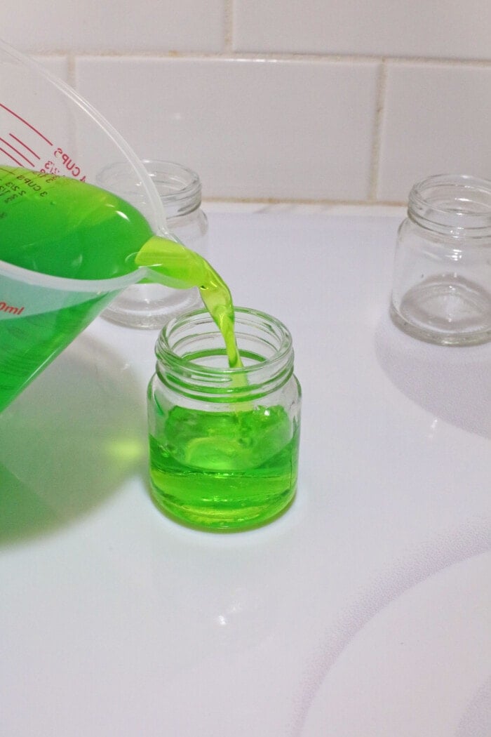 pouring jello mixture into glass mason jar
