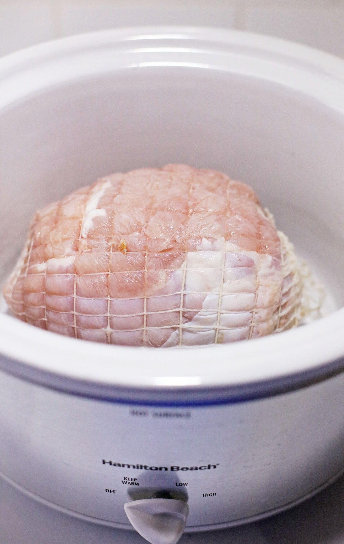 turkey breast in a white crockpot